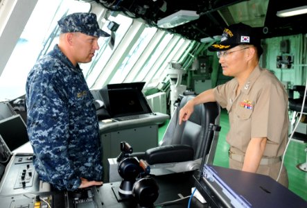 US Navy 100625-N-7058E-095 Cmdr. James Edwards discusses the ship's bridge controls with Cmdr. Yang Min Soo, executive officer of the Republic of Korea guided-missile destroyer ROKS Sejong the Great (DDG 991)