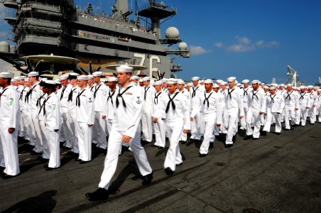 US Navy 100628-N-3659B-015 Sailors aboard the aircraft carrier USS Ronald Reagan (CVN 76) prepare to man the rails before the ship passes the USS Arizona memorial