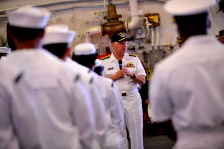 US Navy 100629-N-3548M-368 Chief of Naval Operations (CNO) Adm. Gary Roughead speaks with Sailors and Marines in the hangar bay of the amphibious assault ship USS Wasp (LHD 1) photo