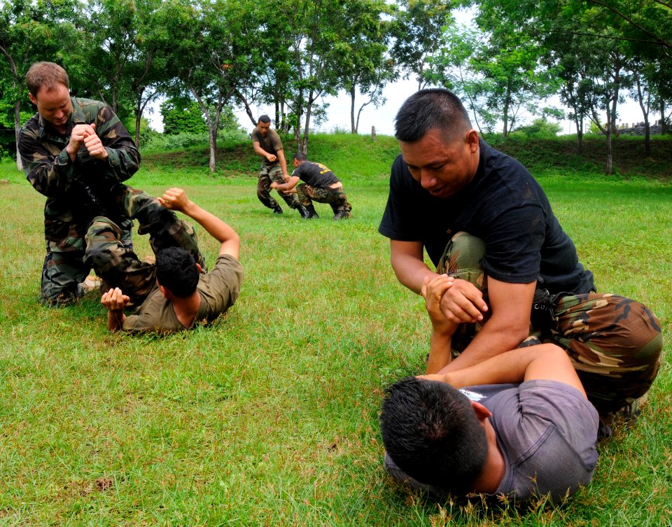 US Navy 100625-N-9643W-544 Equipment Operator 1st Class Daniel Lasich, from Rosenberg, Oregon, teaches a group of El Salvadorian sailors basic takedown techniques