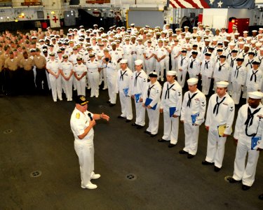 US Navy 100629-N-3548M-317 Chief of Naval Operations (CNO) Adm. Gary Roughead speaks with Sailors and Marines in the hangar bay of the amphibious assault ship USS Wasp (LHD 1) photo