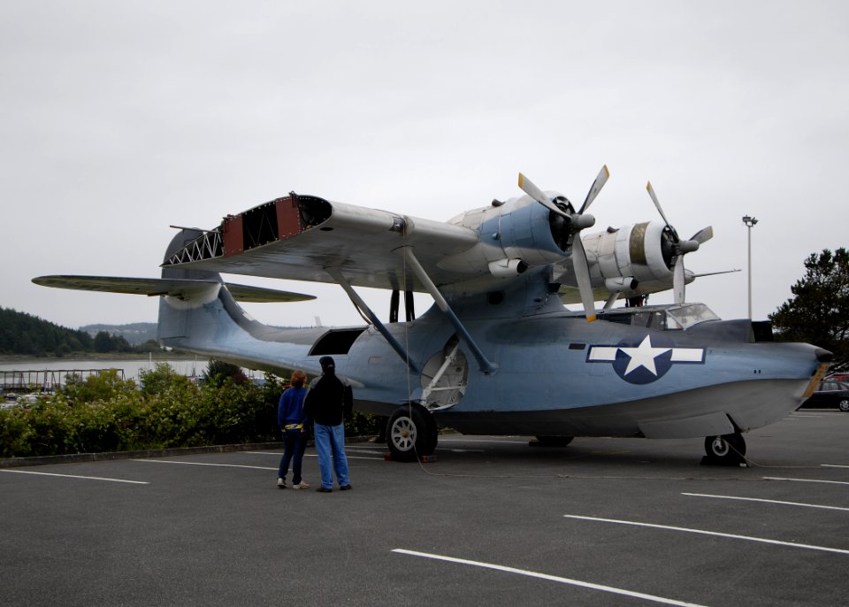 US Navy 100625-N-9520G-004 A father and daughter look at a World War II-era PBY-5A seaplane at Simard Hall at the Naval Air Station Whidbey Island Seaplane Base