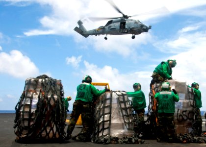 US Navy 100630-N-4830B-050 Supply department Sailors unload supplies delivered aboard the aircraft carrier USS George Washington (CVN 73) during a vertical replenishment photo