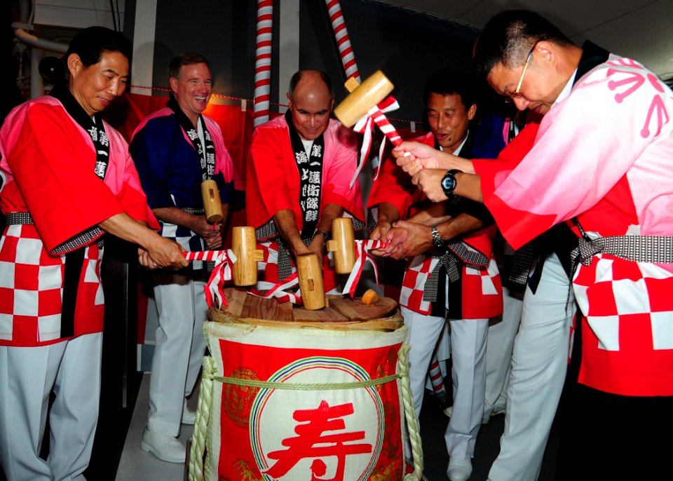 US Navy 100628-N-3570S-075 Senior leaders break the cover of a sake barrel