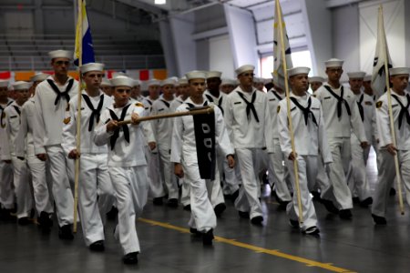 US Navy 100627-O-6890K-002 Sea Cadets assigned to Division 003 presents arms to the official party at USS Midway Ceremonial Drill Hall at Recruit Training Command