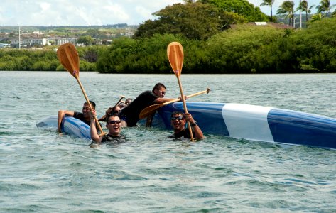 US Navy 100630-N-7200S-110 Sailors from the Republic of Singapore Navy frigate RSS Supreme (70) hang on their overturned outrigger canoe on the last turn of a Rim of the Pacific (RIMPAC) 2010 outrigger canoe race