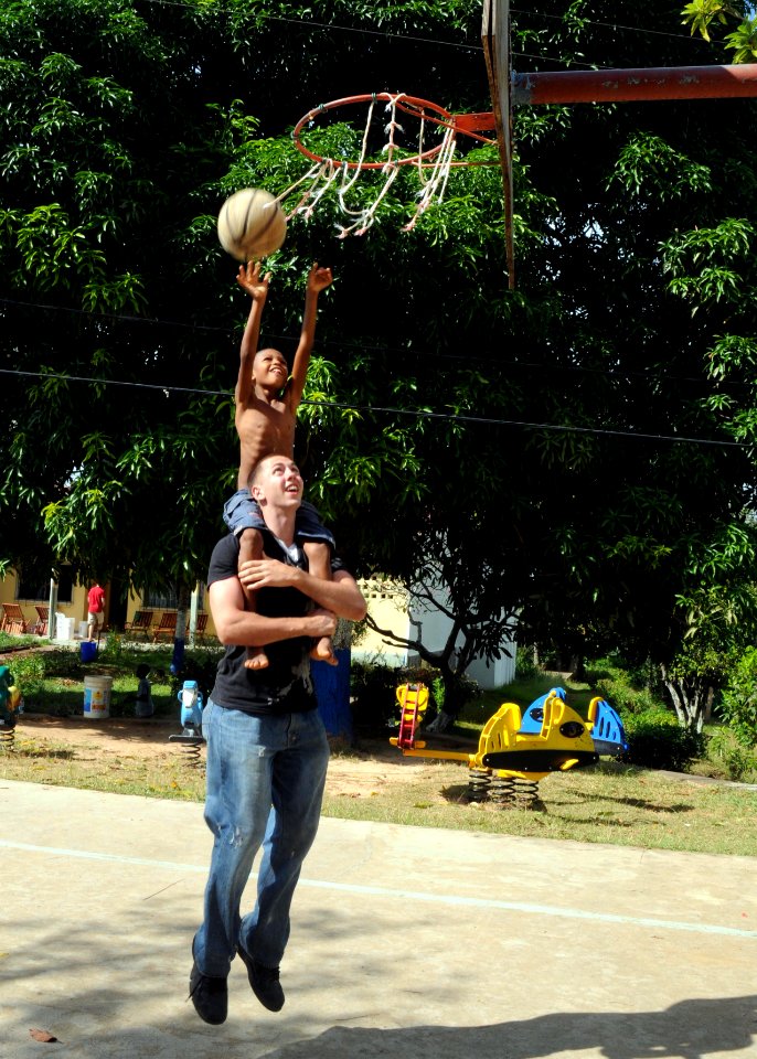 US Navy 100628-N-8936G-068 Lance Cpl. Mark Valanawski, from Birchrun, Mich., plays basketball with a Seychellois boy at the St. Elisabeth orphanage