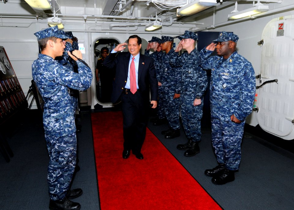 US Navy 100630-N-8913A-006 Minh Tien Nguyen, Deputy Chief of Mission of the Vietnam, passes through side boys aboard the aircraft carrier USS George H.W. Bush (CVN 77) during a visit