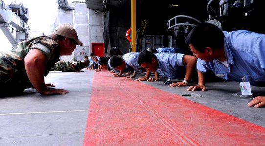 US Navy 100630-N-9643W-068 Equipment Operator 2nd Class Jeremy Hall, from Indiana, left, and Engineman 1st Class Joseph Nicholas, from New York, do pushups with sailors from the El Salvador navy