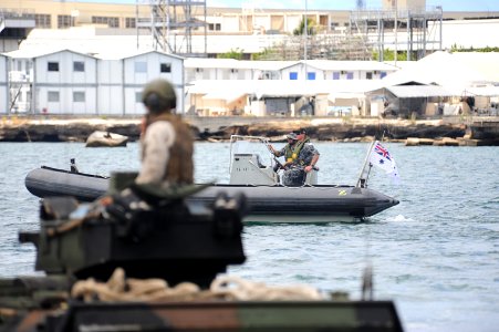 US Navy 100630-N-9500T-212 A Royal Australian Navy rigid-hull inflatable boat guides amphibious tractors