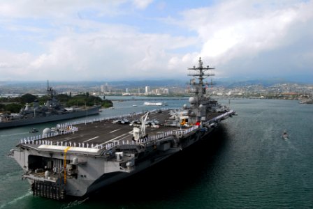 US Navy 100628-N-5684M-756 Sailors and Marines man the rails aboard the aircraft carrier USS Ronald Reagan (CVN 76) as it passes the USS Missouri and USS Arizona memorials in Pearl Harbor photo