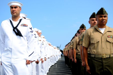 US Navy 100628-N-9132C-186 Marines and Sailors assigned to the Ronald Reagan carrier strike group stand at attention before manning the rails aboard the aircraft carrier USS Ronald Reagan (CVN 76)