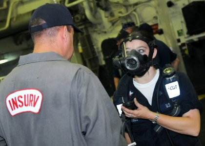 US Navy 100628-N-9950J-053 Hull Technician 3rd Class Rachel Stubbs demonstrates how to use a self-contained breathing apparatus as part of Inspection and Survey
