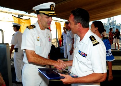 US Navy 100630-N-3570S-031 Capt. Gregory R. Thomas presents French navy Cmdr. Renaud Bondil, commanding officer of the French navy frigate Prairial (F 731)