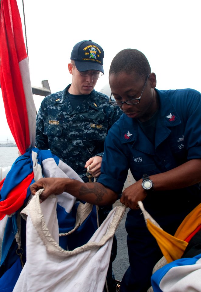 US Navy 100701-N-5319A-019 Quartermaster 1st Class Martez Smith and Ensign Andrew Norris prepare signal flags during flag signaling drills