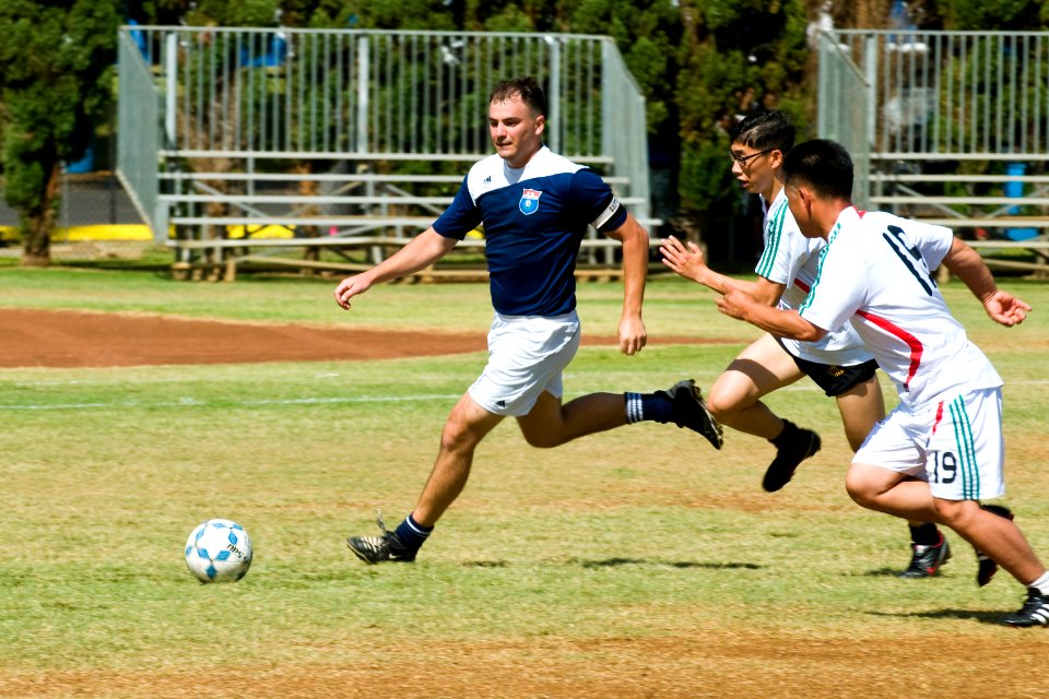 US Navy 100630-N-6674H-004 A Sailor assigned to the amphibious assault ship USS Bonhomme Richard (LHD 6) drives the ball downfield during a Rim of the Pacific (RIMPAC) 2010 sports cup soccer competition