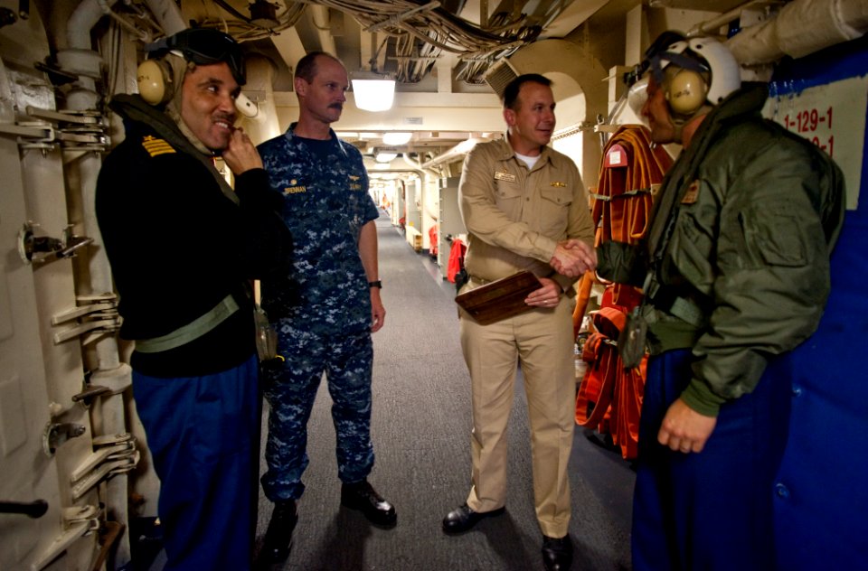 US Navy 100701-N-5319A-062 Cmdr. Jeffrey Oakey and Capt. Peter Brennan end a tour of USS New Orleans (LPD 18) with Cmdr. Scott Smith and Capt. Brian Nickerson