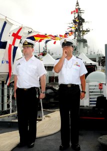 US Navy 100701-N-8539M-074 Lt. Les Gunderson and Leading Seaman Pierre Ouellet participate in a morning colors ceremony aboard the Royal Canadian Navy destroyer HMCS Algonquin (DDG 283)