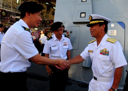 US Navy 100702-N-3570S-008 Singapore navy Capt. Giam Hock Koon welcomes aboard Rear Adm. Kazuki Yamashita to Rim of Pacific (RIMPAC) 2010 Singapore Reception