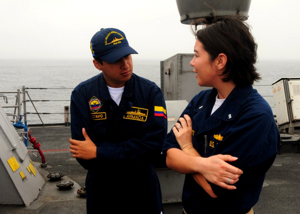US Navy 100630-N-9301W-298 Lt. j.g. Amelia Abbett answers the questions of a visiting Colombian naval officer during a tour aboard the guided-missile frigate USS Klakring (FFG 42) during naval exercises off the coast of Peru