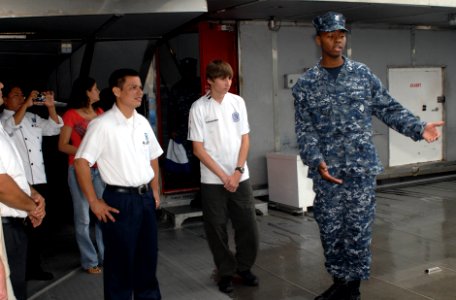 US Navy 100629-N-4971L-243 Logistics Specialist 1st Class Eric Jones, right, from Tifton, Ga., gives a tour of High Speed Vessel Swift (HSV 2)