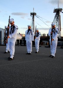 US Navy 100702-N-7642M-329 The Silver Dolphins, the precision rifle and flag drill team, perform a silent gun drill in the Sunset Parade at the Charlestown Navy Yard