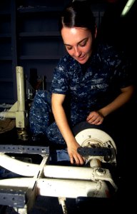 US Navy 100629-N-4135M-157 Aviation Ordnanceman Airman Cortney Firestone performs preventative maintenance on an MHU-191 munitions transporter