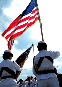 US Navy 100702-N-5148B-012 Service members salute the U.S. flag aboard the USS Midway Museum during a military naturalization ceremony
