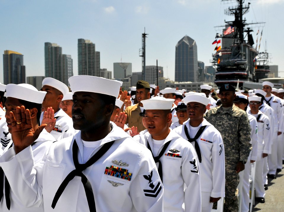 US Navy 100702-N-7981E-447 Service members recite the oath of citizenship during a naturalization ceremony on the flight deck of the USS Midway Museum. T