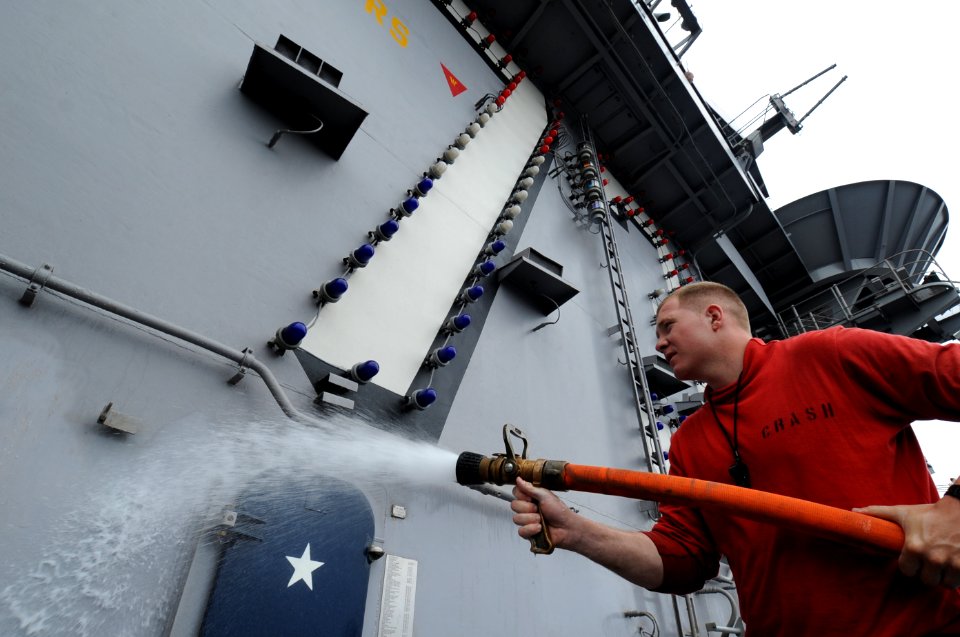 US Navy 100703-N-7191M-023 Aviation Boatswain's Mate (Handling) Airman Steven Oliver from Detroit, washes down the superstructure aboard the aircraft carrier USS George Washington (CVN 73)