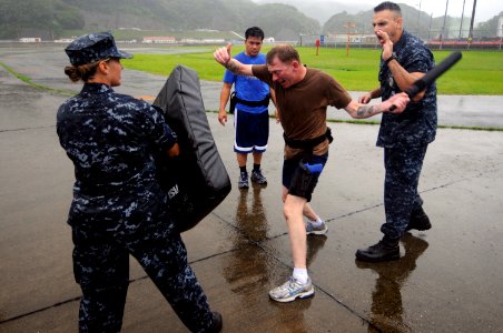 US Navy 100629-N-8335D-913 Machinist's Mate 2nd Class Dale Palmer, suffering the blinding effects of Oleoresin Capsicum (OC) spray, uses a baton during an auxiliary security force training course