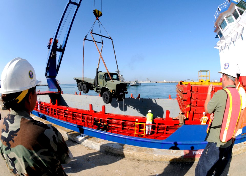 US Navy 100701-N-6357K-002 Chief Builder Diane Paddock, assigned to Naval Mobile Construction Battalion (NMCB) 7, observes the loading of a medium tactical vehicle replacement (MTVR) for transport to the detail's operating site