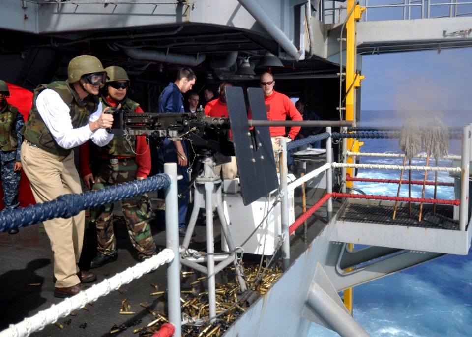 US Navy 100630-N-2013O-323 Capt. David Lausman, commanding officer of the aircraft carrier USS George Washington (CVN 73), fires an M2 .50-caliber machine gun during a .50-caliber qualification shoot