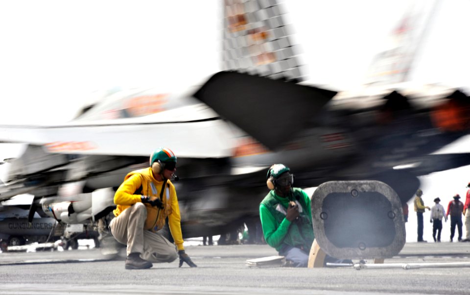 US Navy 100704-N-6003P-072 A flight deck shooter and a catapult operator watch as an F-A-18C Hornet, assigned to the Checkerboards of Marine Fighter Attack Squadron (VMFA) 312, launches from the aircraft carrier USS Harry S. Tr
