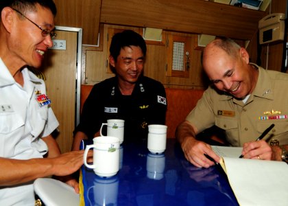 US Navy 100701-N-3570S-045 Vice Adm. Richard W. Hunt, right, commander of Combined Joint Task Force, signs the guest log aboard the Republic of Korea submarine (ROKS) Lee Eokgi (SS 071) as Cmdr. Suyoul Lee,