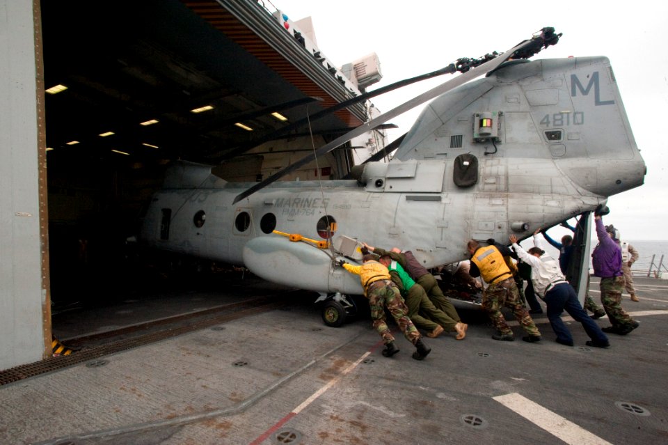 US Navy 100701-N-5319A-034 Crew members push a Marine CH-46 Sea Knight helicopter into the hanger bay of USS New Orleans (LPD 18)