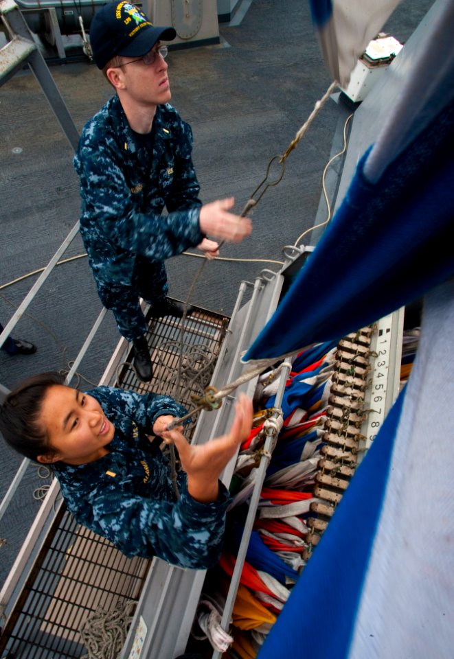 US Navy 100701-N-5319A-026 Ensigns Jessica Alabata and Andrew Norris take turns raising signal flags during flag signaling drills