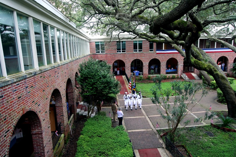US Navy 100701-N-4482V-001 Sailors assigned to the color guard detail at Naval Air Technical Training Center, present the colors in the courtyard of Naval Education and Training Command during a patriotic luncheon