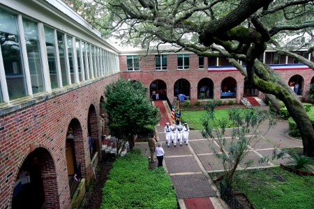 US Navy 100701-N-4482V-001 Sailors assigned to the color guard detail at Naval Air Technical Training Center, present the colors in the courtyard of Naval Education and Training Command during a patriotic luncheon
