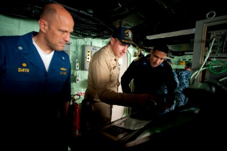 US Navy 100701-N-5319A-048 Cmdr. Jeffrey Oakey gives a tour of the ship's bridge to Cmdr. Scott Smith and Capt. Brian Nickerson