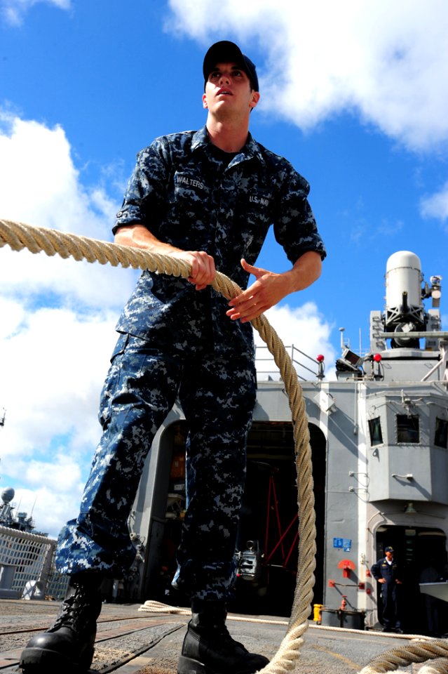 US Navy 100706-N-7200S-017 Fire Controlman 2nd Class Kevin Walters hauls in a mooring line during sea and anchor detail aboard the guided-missile frigate USS McClusky (FFG 41) while getting underway for Rim of the Pacific (RIMP