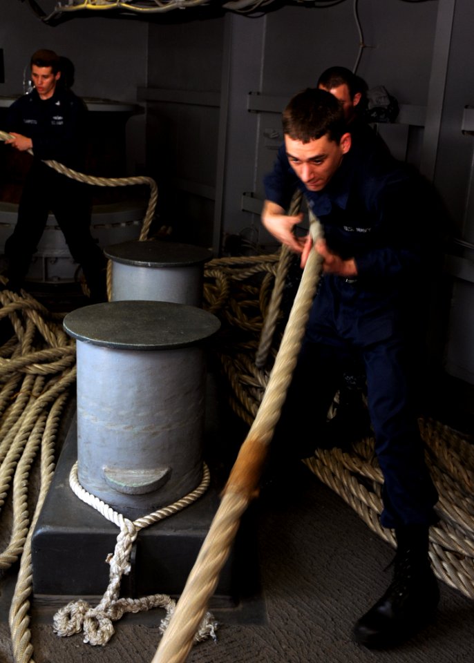 US Navy 100707-N-2908M-002 Ship's Serviceman Seaman Elliott Walker and Information System Technician 3rd Class Thomas Scarpitto prepare to heave in mooring lines during sea and anchor detail aboard USS Kearsarge (LHD3