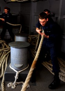 US Navy 100707-N-2908M-002 Ship's Serviceman Seaman Elliott Walker and Information System Technician 3rd Class Thomas Scarpitto prepare to heave in mooring lines during sea and anchor detail aboard USS Kearsarge (LHD3