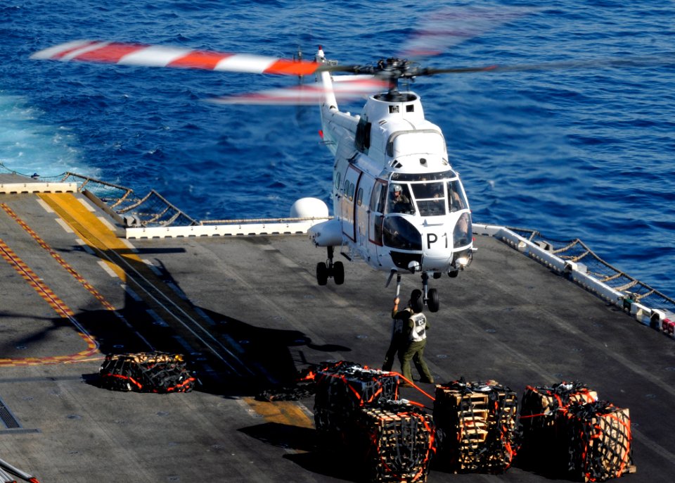 US Navy 100707-N-3729D-043 Marine combat cargomen attach a pole pendant to a SA-330 Puma helicopter assigned to the Military Sealift Command dry cargo and ammunition ship USNS Amelia Earhart (T-AKE 6) aboard the amphibious assa