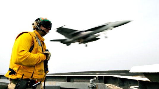 US Navy 100705-N-6003P-079 Lt. Michael Grimmett waits for an approaching F-A-18E Super Hornet assigned to the Gunslingers of Strike Fighter Squadron (VFA) 105 to trap the wire aboard the aircraft carrier USS Harry S. Truman