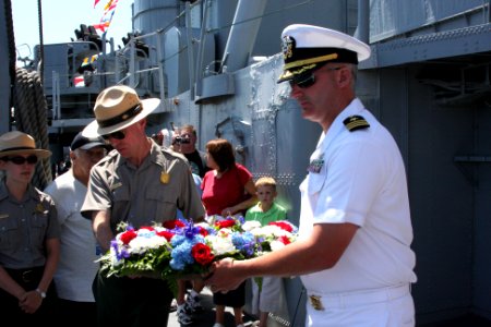 US Navy 100703-N-3038C-207 Cmdr. Stephen Fuller, right, commanding officer of the guided-missile frigate USS Hawes (FFG 53) and a National Park Service ranger prepare to place a wreath in the water to honor World War II