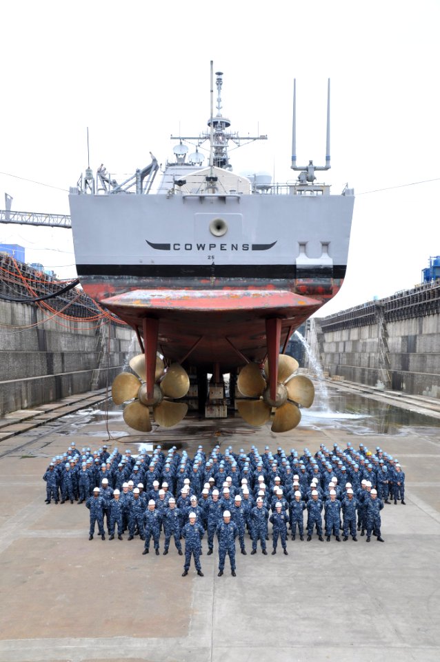 US Navy 100706-N-0000X-001 The officers and crew of the guided-missile cruiser USS Cowpens (CG 63) pose for a group photo under the ship at Fleet Activities Yokosuka's dry dock six