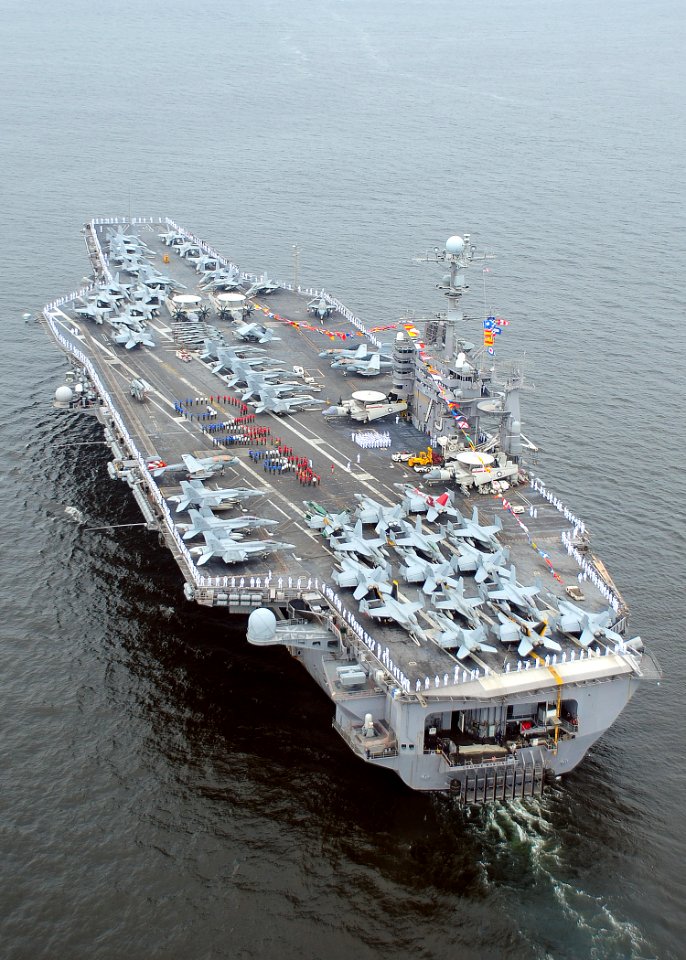 US Navy 100703-N-6720T-029 Sailors aboard the aircraft carrier USS George Washington (CVN 73) spell out GW 18th on the flight deck while arriving in port to commemorate the ship's 18 years of Naval service since her commissioni