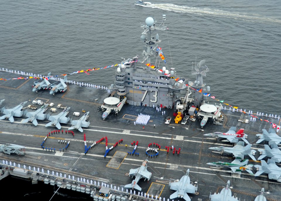 US Navy 100703-N-6720T-030 Sailors aboard the aircraft carrier USS George Washington (CVN 73) spell out George Washington on the flight deck while arriving in port to commemorate the ship's 18 years of Naval service