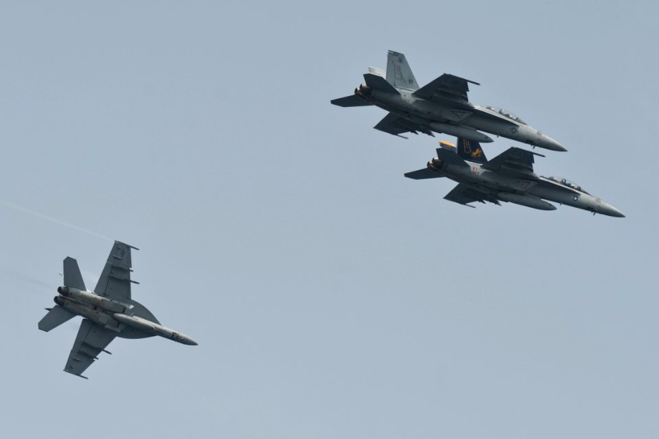 US Navy 100703-N-7317W-019 F-A-18F Super Hornets assigned to the Swordsmen of Strike Fighter Squadron (VFA) 32 fly by the aircraft carrier USS Harry S. Truman (CVN 75) in formation during a change of command ceremony